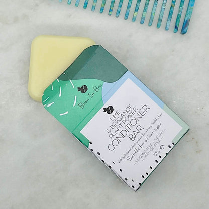 Plastic-free conditioner bar from Bean & Bear for hydrated, frizz-free curls on a marble surface.