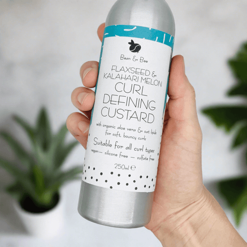 Flaxseed and Kalahari Melon curl defining custard for soft, bouncy curls in a sleek aluminum bottle.