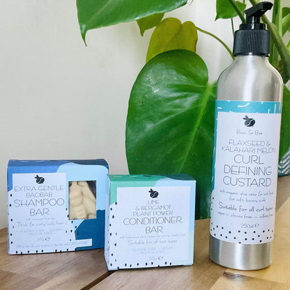 Curly hair care products: shampoo bar, conditioner bar, and curl defining custard for hydrated, frizz-free curls.